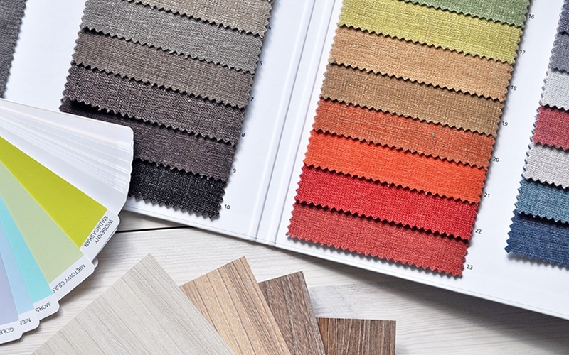 Samples of color fabric, paint chips, and wood panel squares.