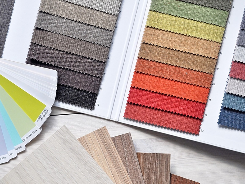 Samples of color fabric, paint chips, and wood panel squares.