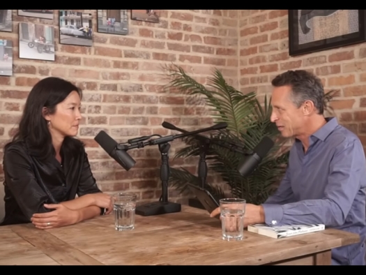 Screenshot from video: Cynthia LI & Mark Hyman sit at a table with microphones