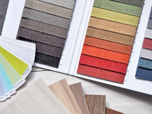 Samples of color fabric, paint chips, and wood panel squares.